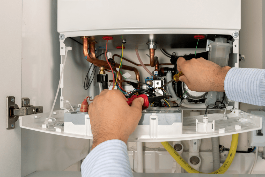 Technician performing boiler maintenance and cleaning in Victoria to prevent breakdowns